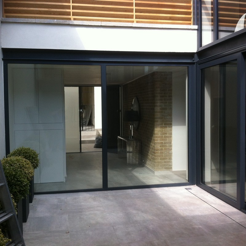 Floor-to-ceiling sliding doors opening to courtyard in High Wycombe