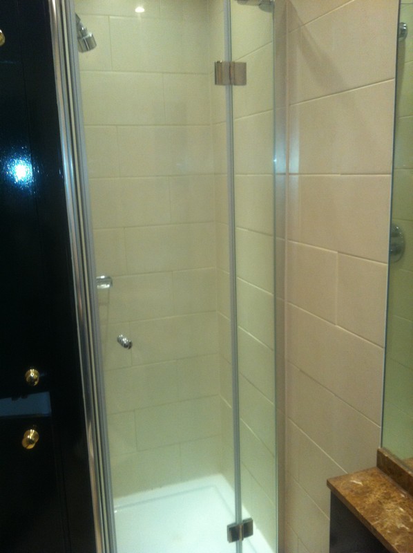 Frameless glass shower enclosure with chrome fittings in High Wycombe
